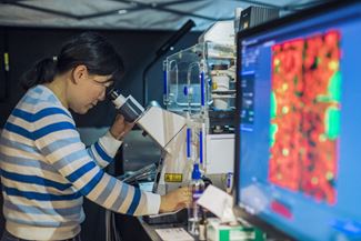 Student using extensive microscopy resources in John Lemaster’s lab