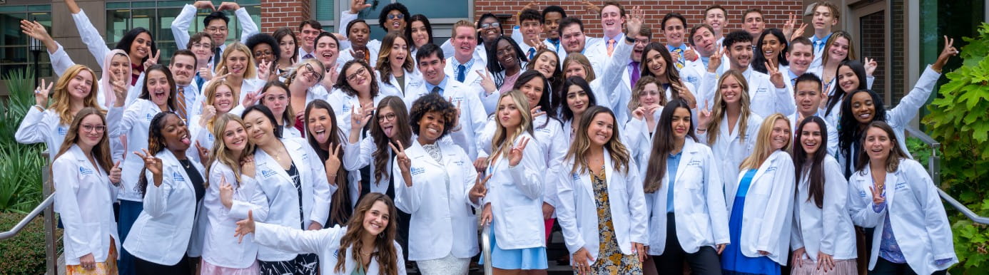 MUSC College of Pharmacy students in white coats