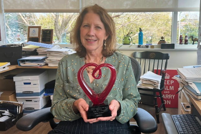 Kathy Chessman holding award