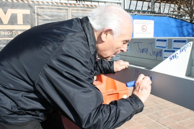 Dean Emeritus Bill Golod signing beam for new pharmacy facility