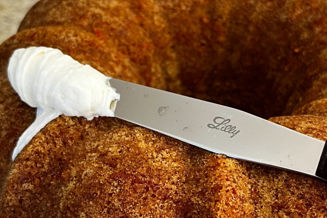 Eli Lily compounding knife icing a cake