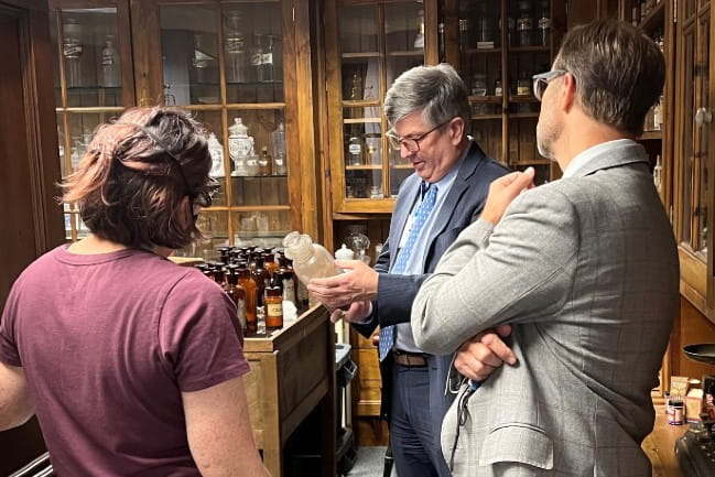 Brooke Fox, Brian Fors and Philip Hall in the pharmacy museum