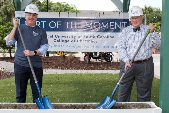 philip hall and peter edwards posing with shovels at pharmacy groundbreaking